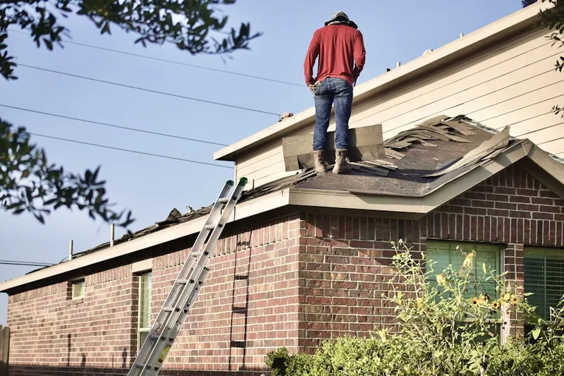 Professional roofer working on a residential roof in New Berlinville